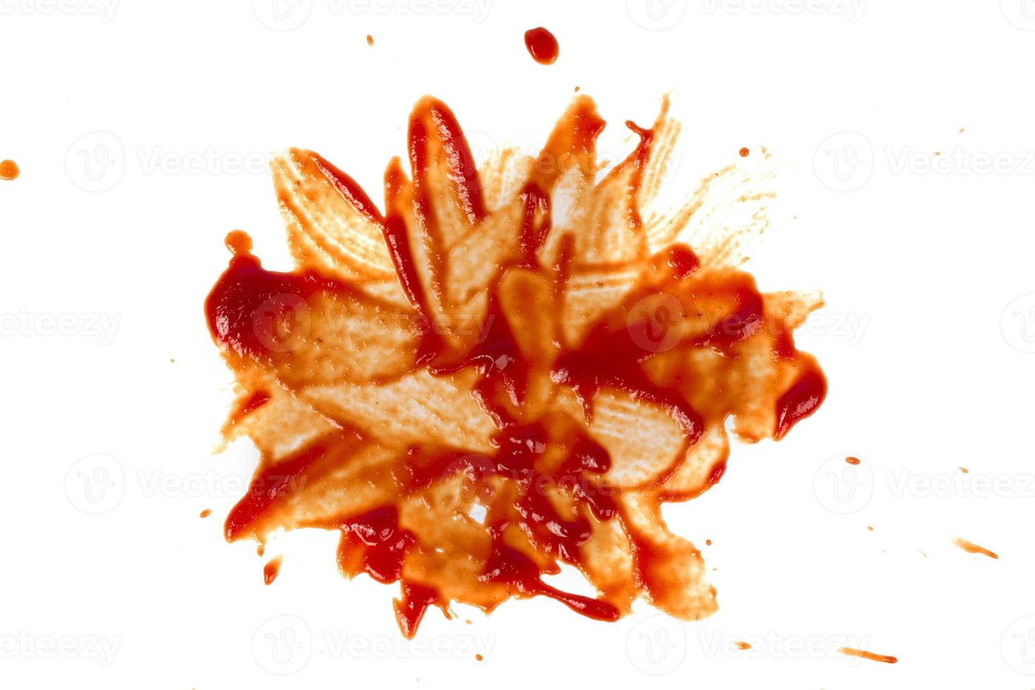 Red stain from ketchup smeared on a white background. photo