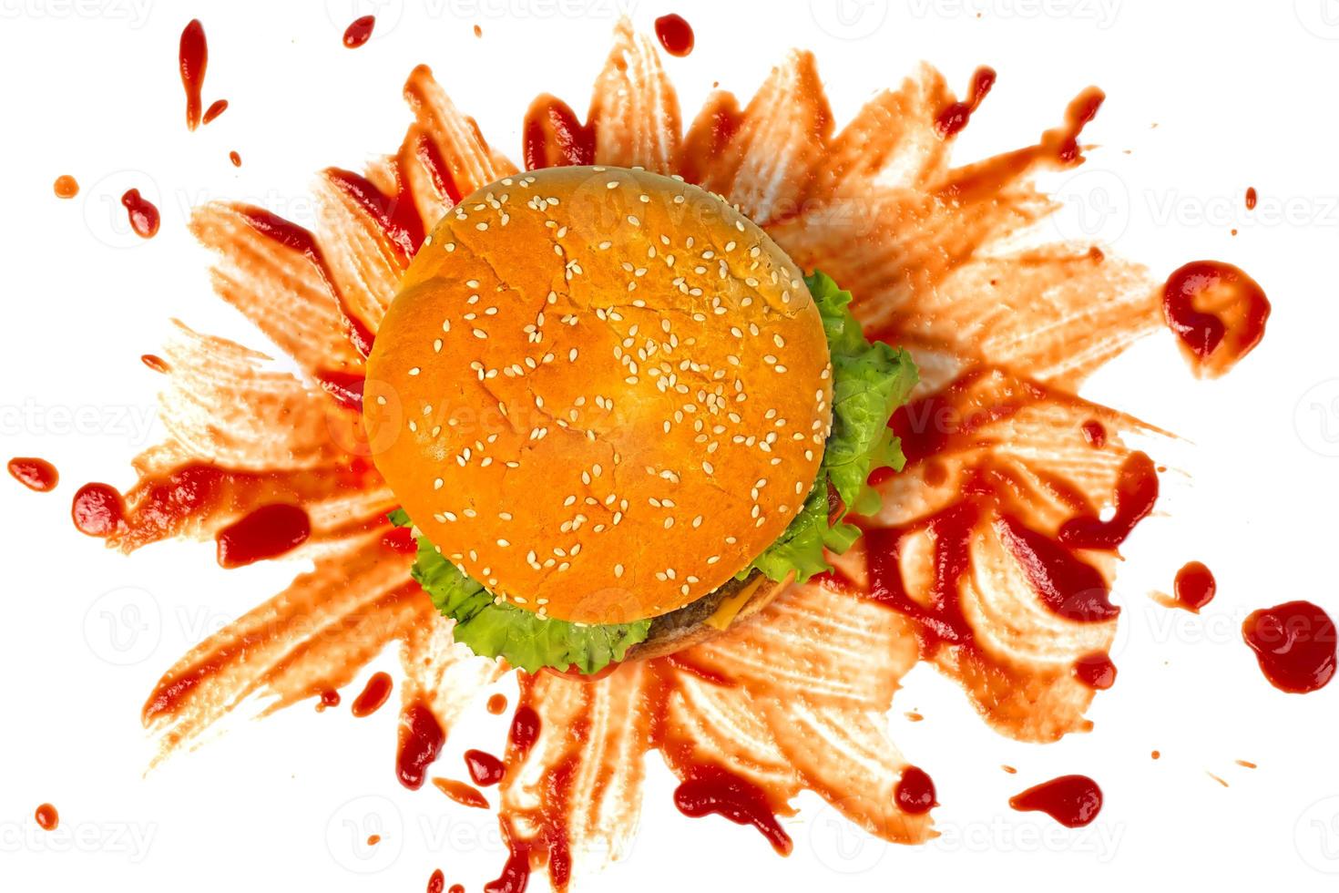 Hamburger on a background of splattered ketchup on a white background.Creative hamburger. photo