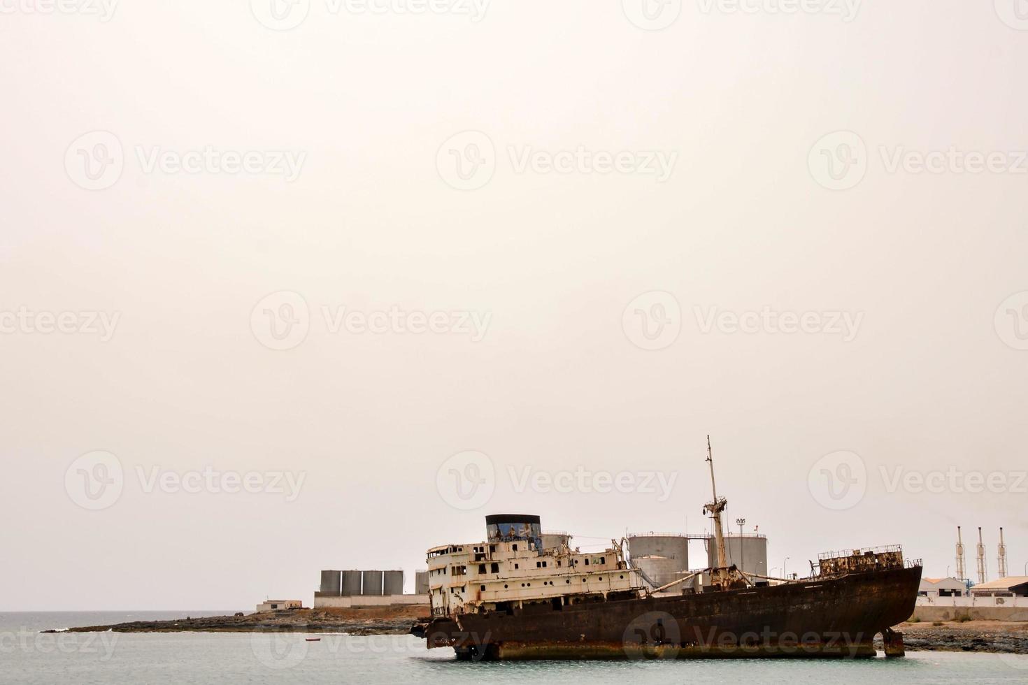 Abandoned ship by the coast photo