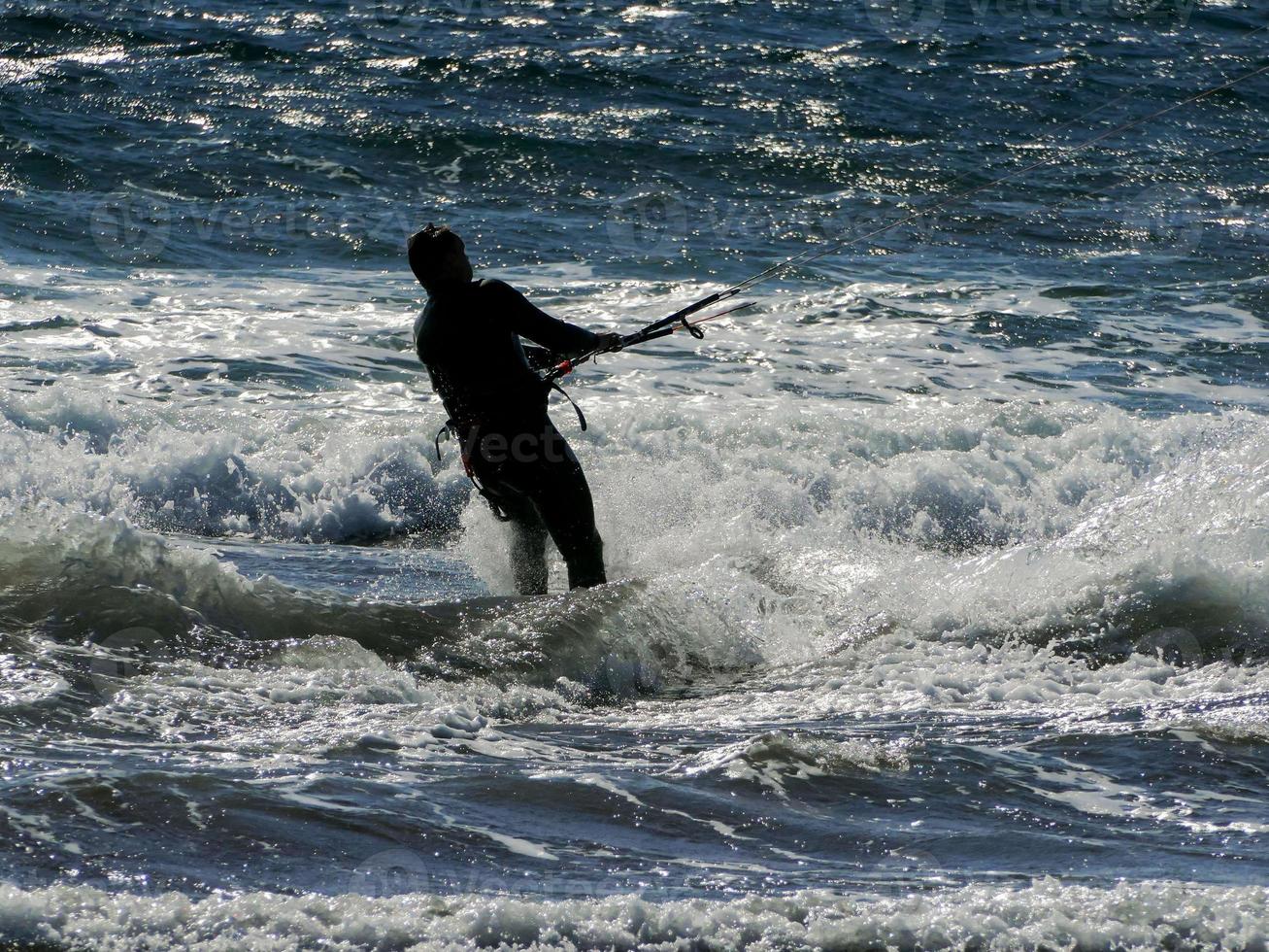 Silhouette of a kite surfer photo