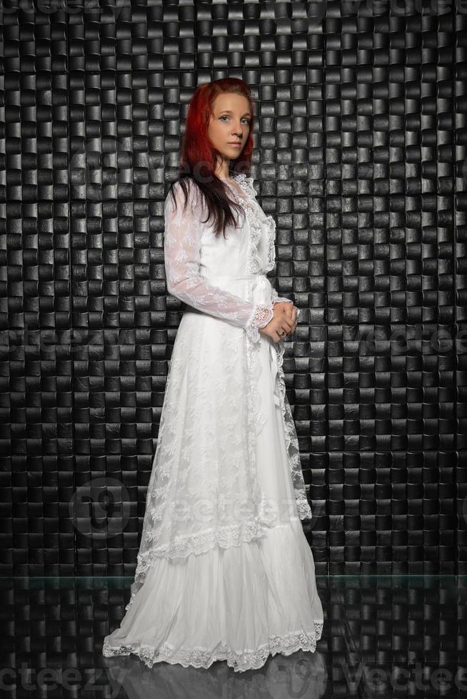 Alluring redhead lady posing in studio photo