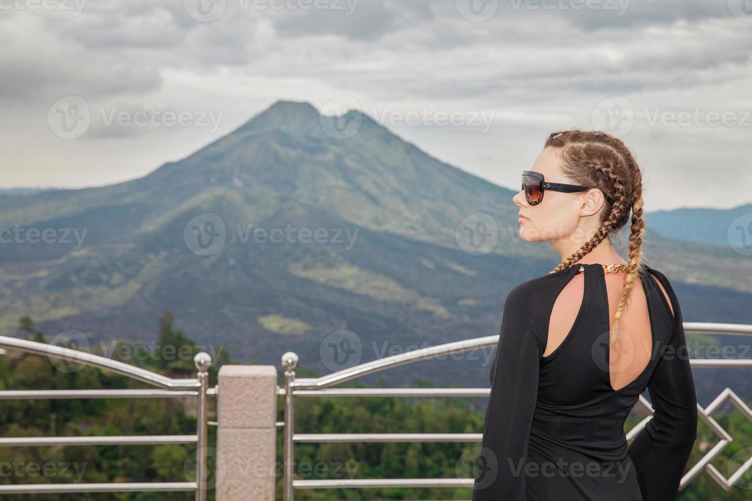 Charming woman against the backdrop of the volcano Batur photo