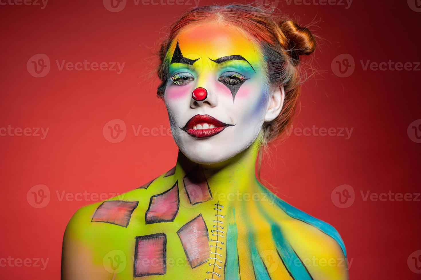 Nice young woman with a aqua makeup clown photo