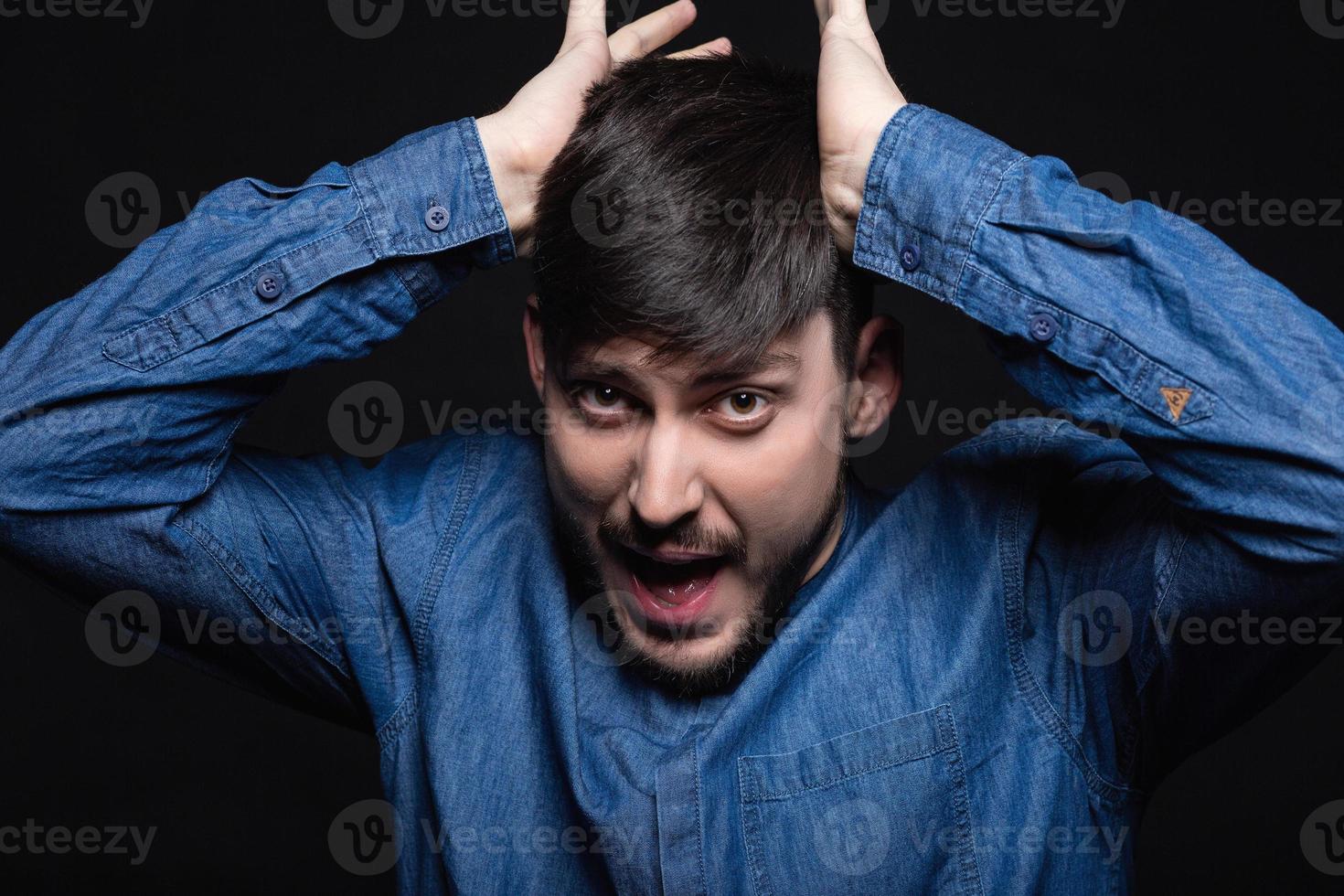 Alluring man screaming posing in studio photo