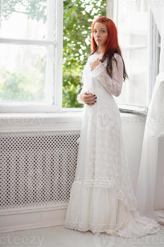 Beautiful lady posing near the window photo