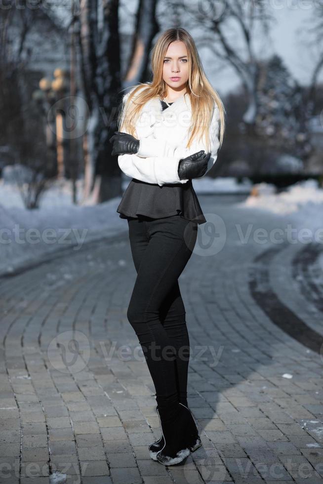 Thoughtful young blonde posing in winter photo