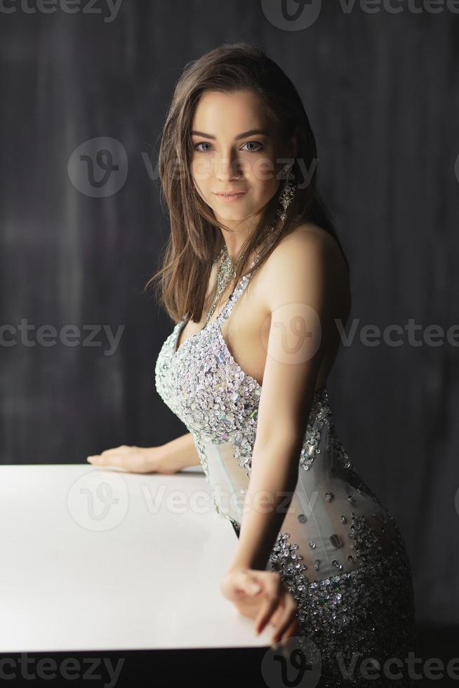 Charming young woman posing in a studio photo