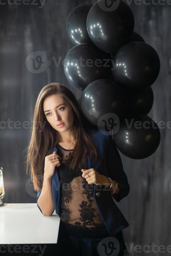 Young adorable lady posing near balloons photo