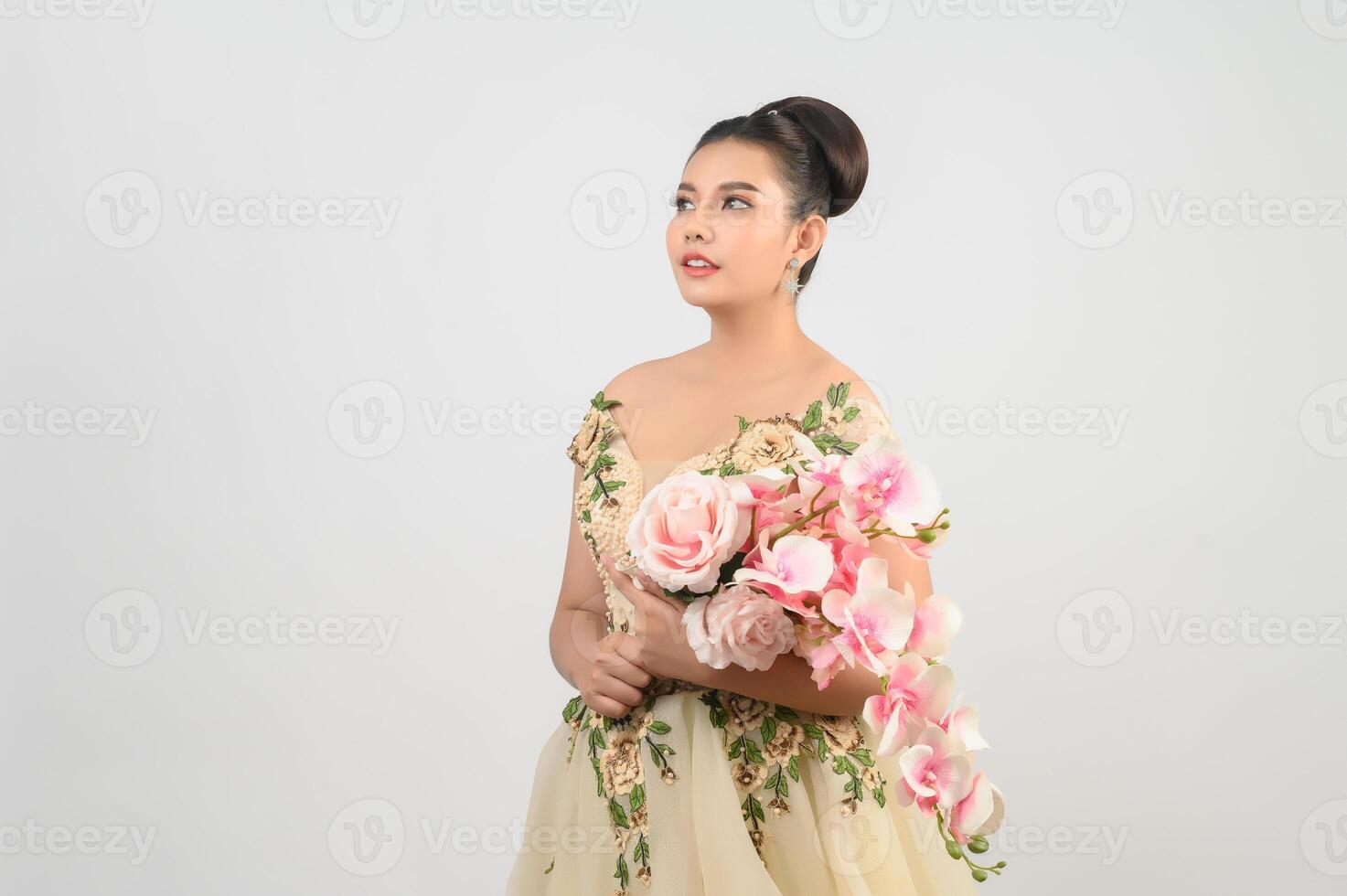 Young asian beautiful bride with orchid bouquet on white background photo