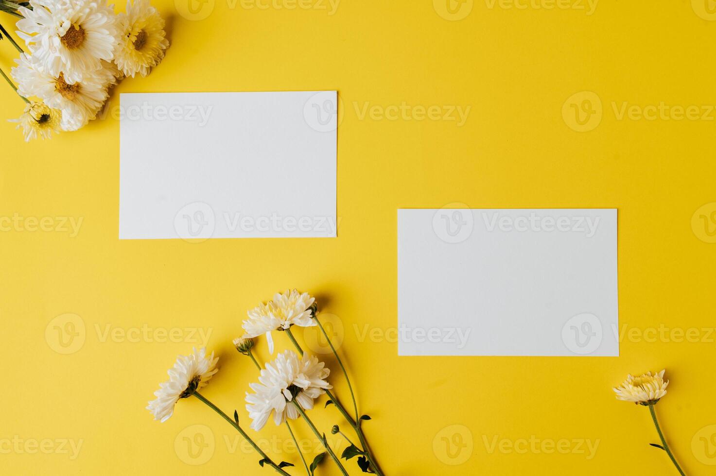 White card on dark yellow background with flowers. photo