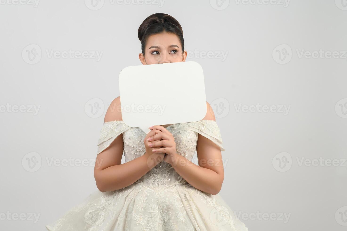 Young asian beautiful bride pose with mockup banner in hand photo