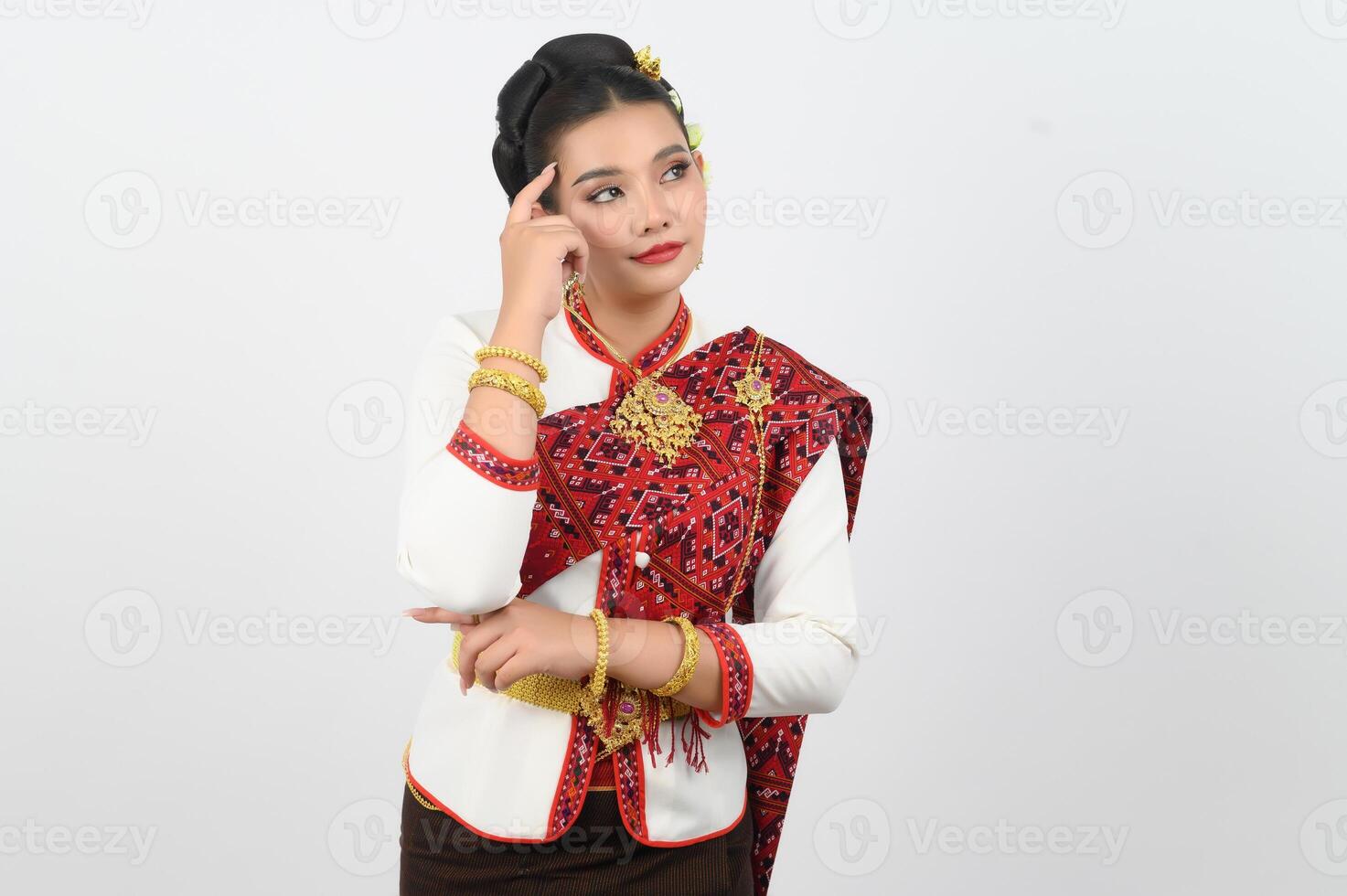 Young beautiful woman in Thai lanna costume with thoughtful posture photo