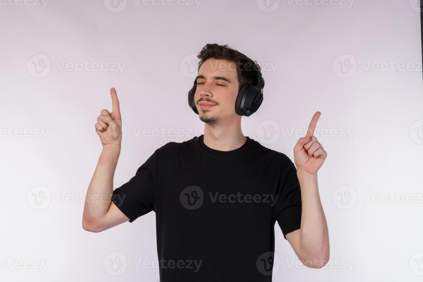 Portrait of happy young man wearing headphone and enjoy music over white background photo