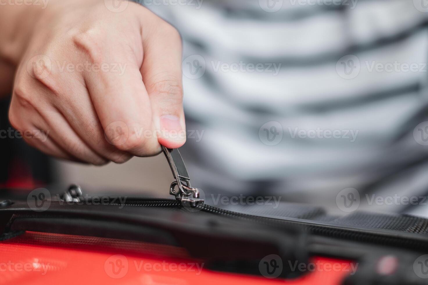 Close-up of man have finished packing and is locking them photo