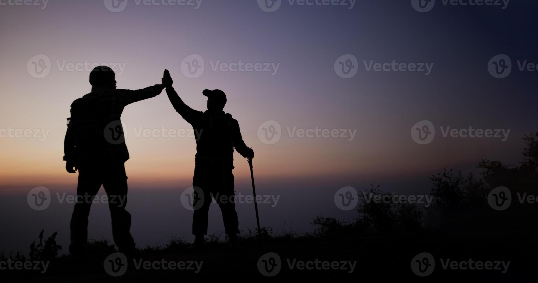 Silhouette of Teamwork helping hand trust help photo