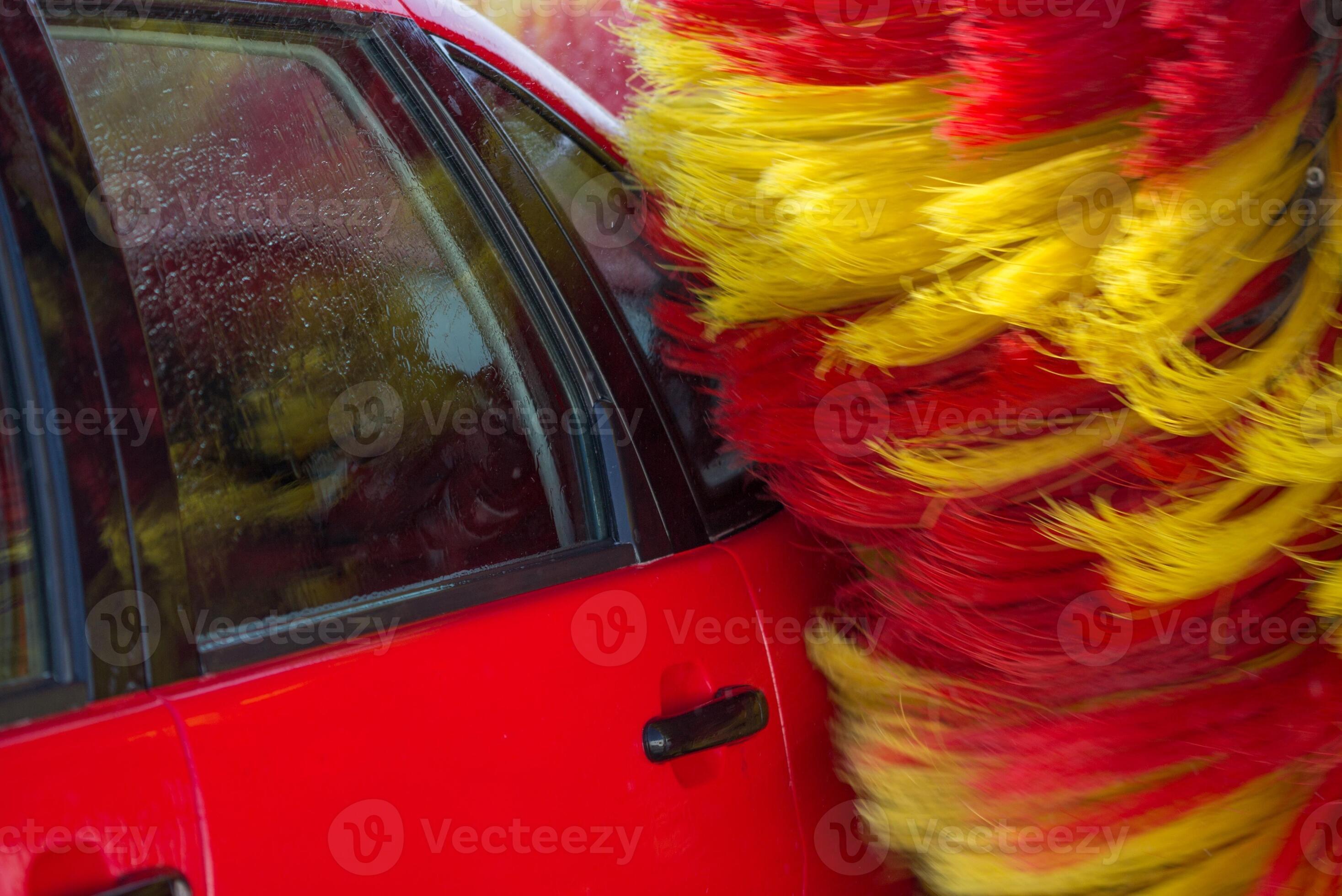 Worker washing car with sponge on a car wash, Manual car wash with