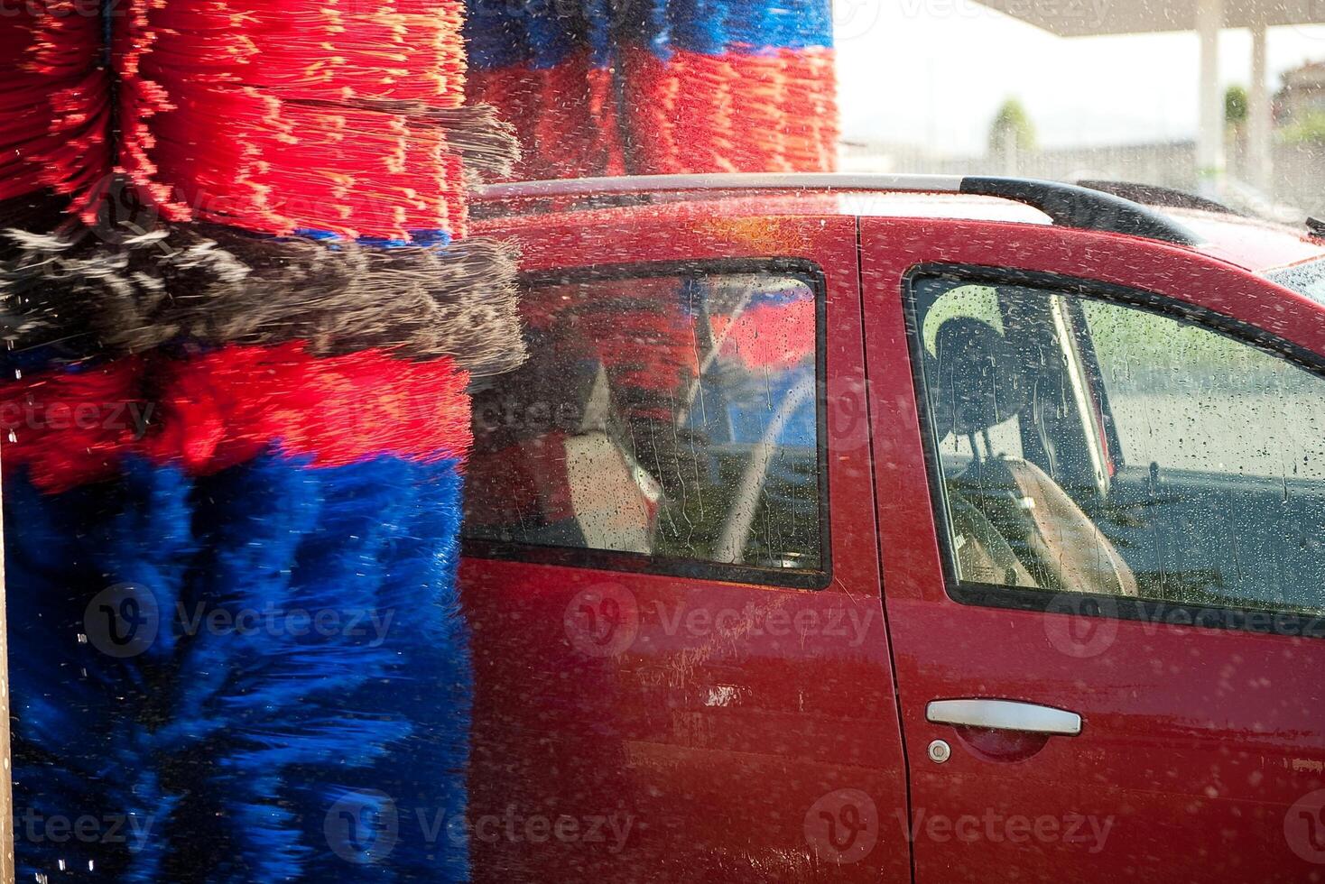 Worker washing car with sponge on a car wash, Manual car wash with