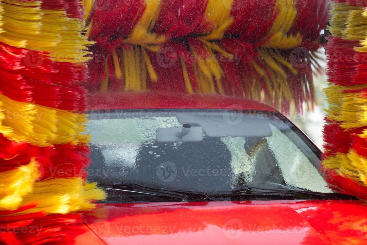 Worker washing car with sponge on a car wash, Manual car wash with