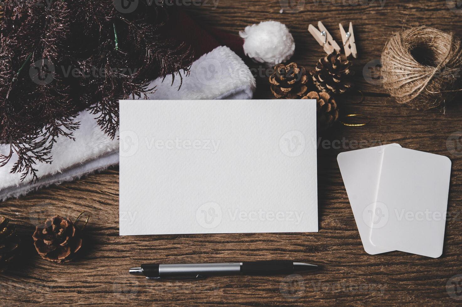 white sheet of paper lying among small decorations on  wooden desk. photo