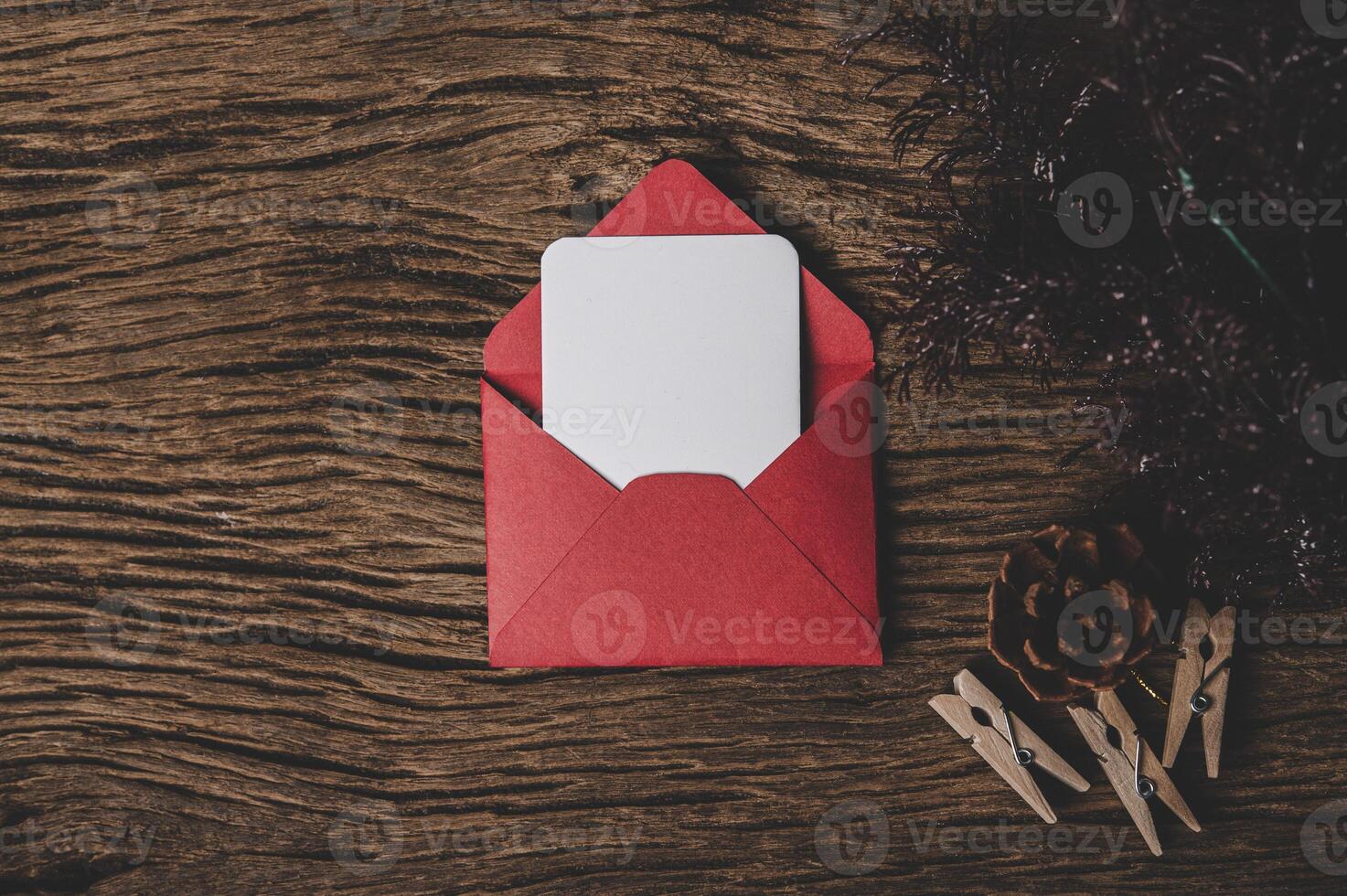 envelope of paper lying among small decorations on wooden desk. photo