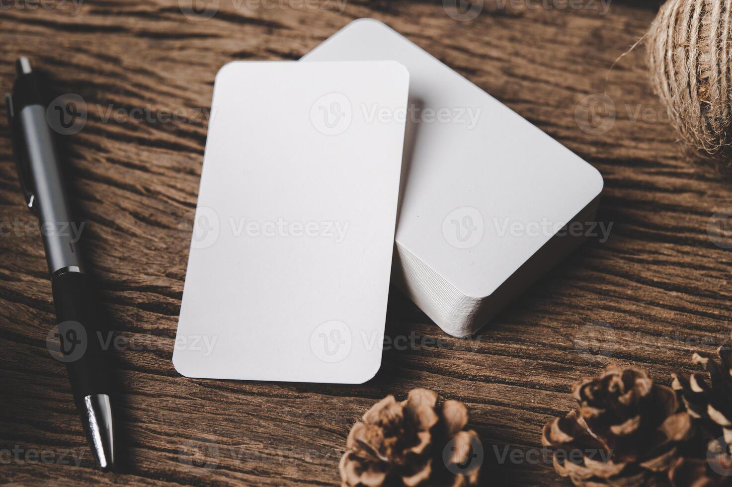 white sheet of paper lying among small decorations on  wooden desk. photo