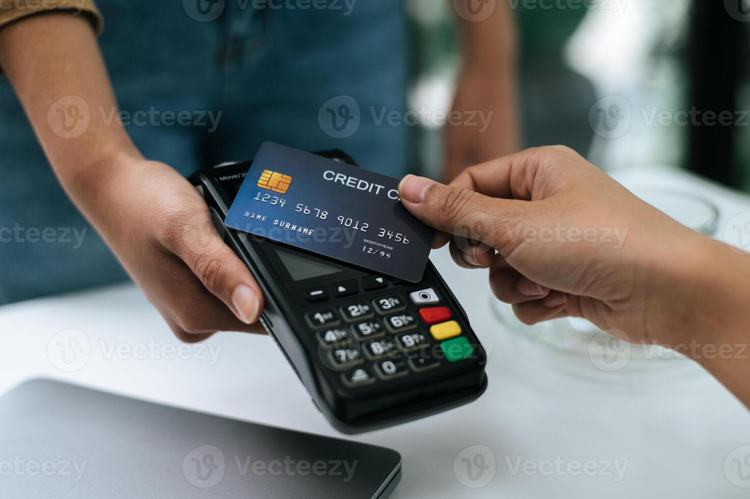 Young woman paying order having contactless payment with cardit card photo