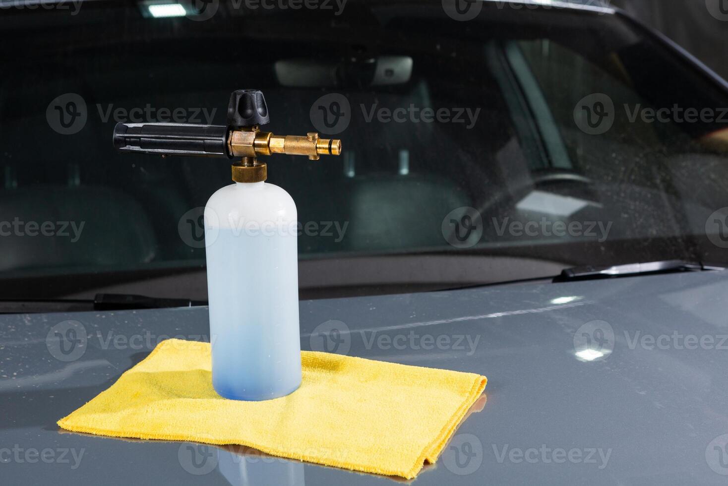 Worker washing car with sponge on a car wash, Manual car wash with