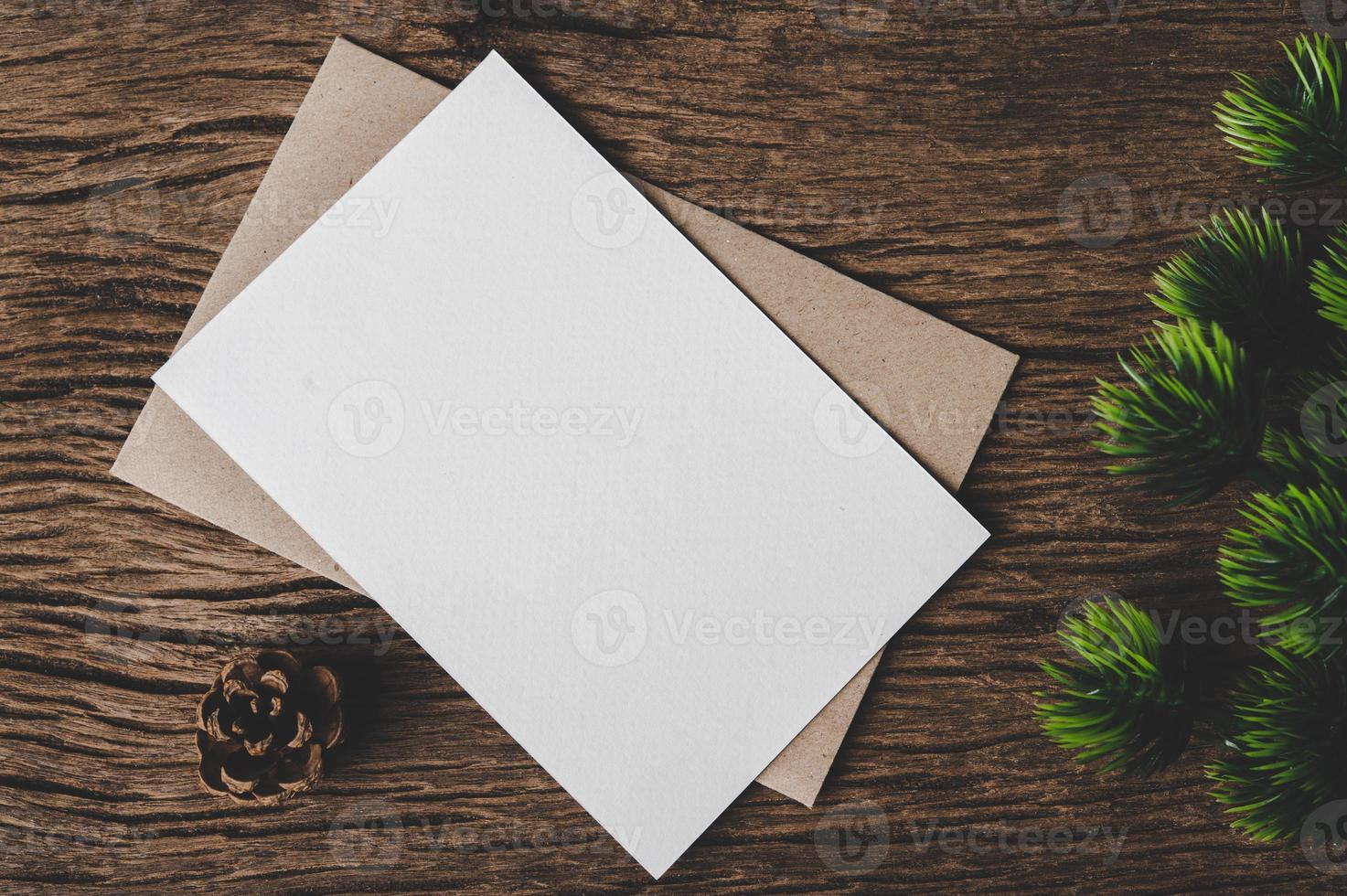 envelope of paper lying among small decorations on wooden desk. photo