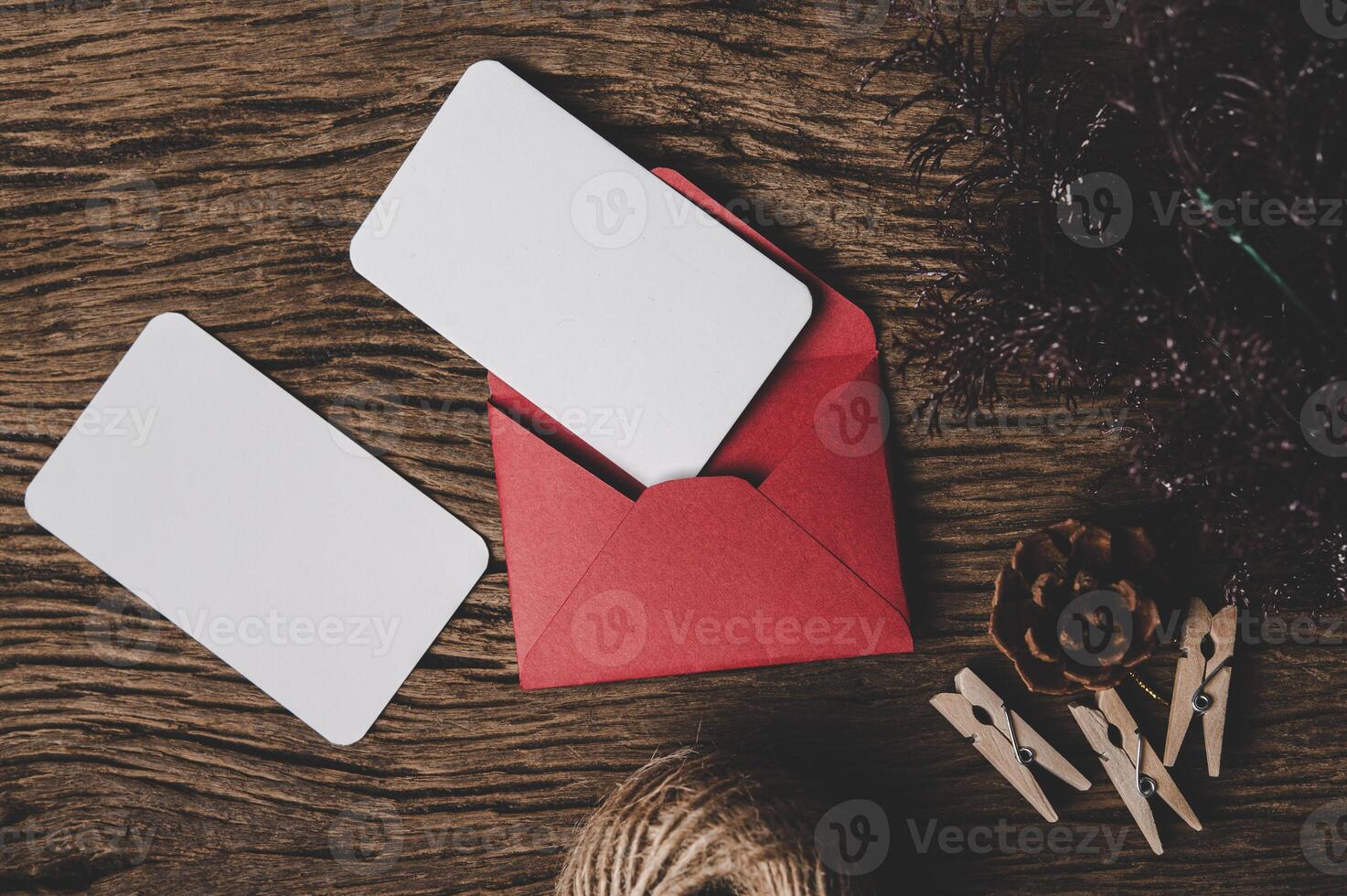 envelope of paper lying among small decorations on wooden desk. photo