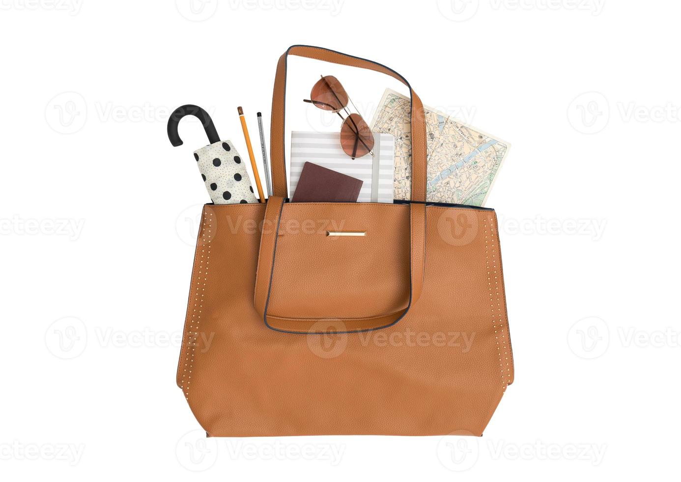 2026 Brown purse with a umbrella, sunglasses, map and passport isolated on a transparent background photo
