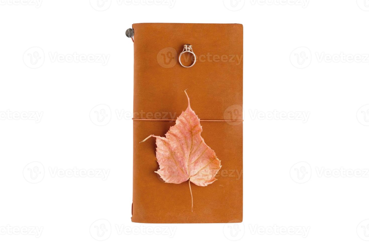 4126 Brown notebook, ring and leaf isolated on a transparent background photo