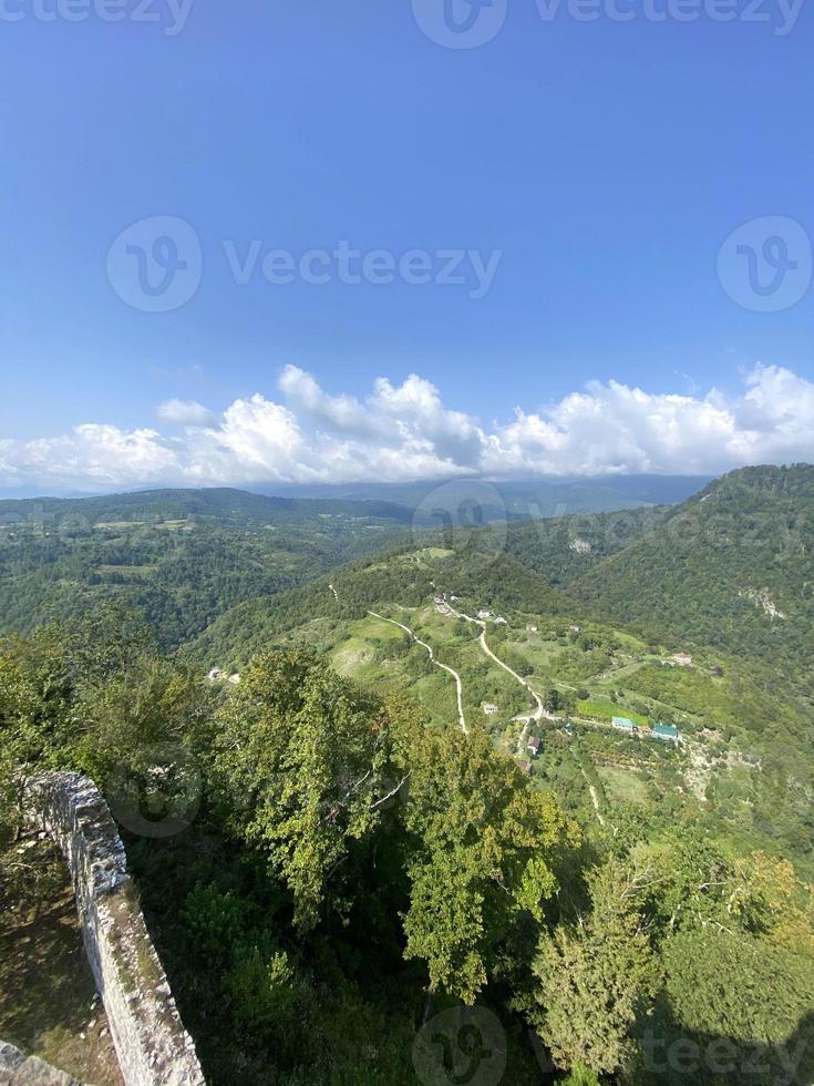 View from the green top of the mountain. Overview of mountains and sky. photo