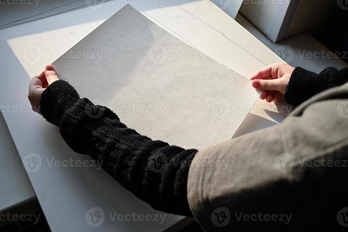 Close-up of children's hands drawing with a pencil on white paper. In the process of work. photo