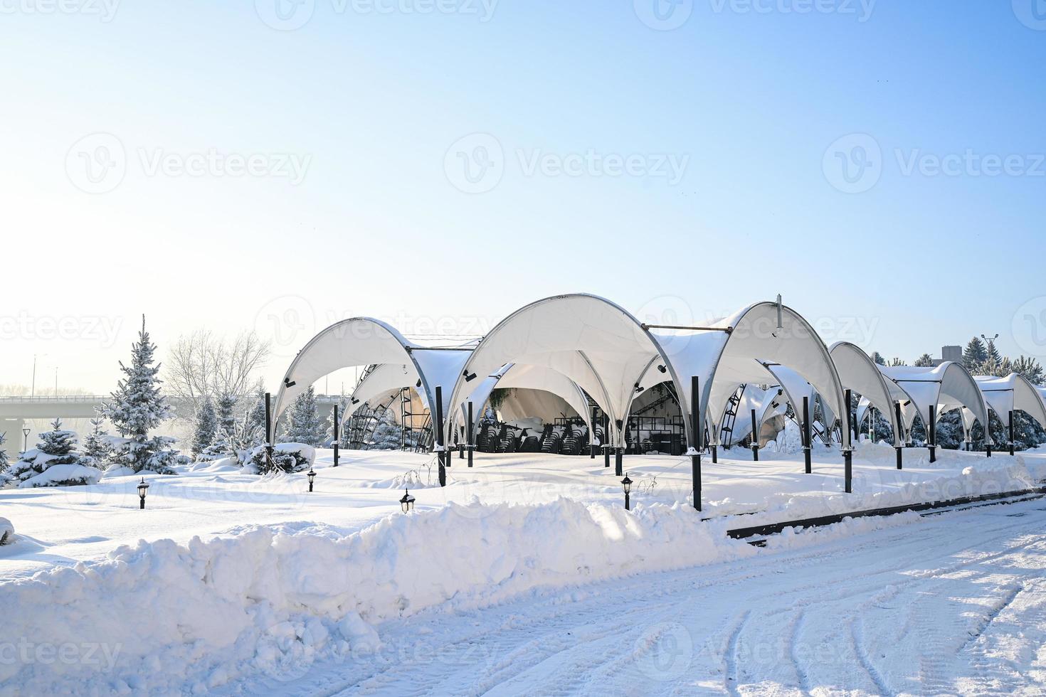 Winter road, Christmas trees in the snow. A track in a winter snow scene. Snowy, evening. photo