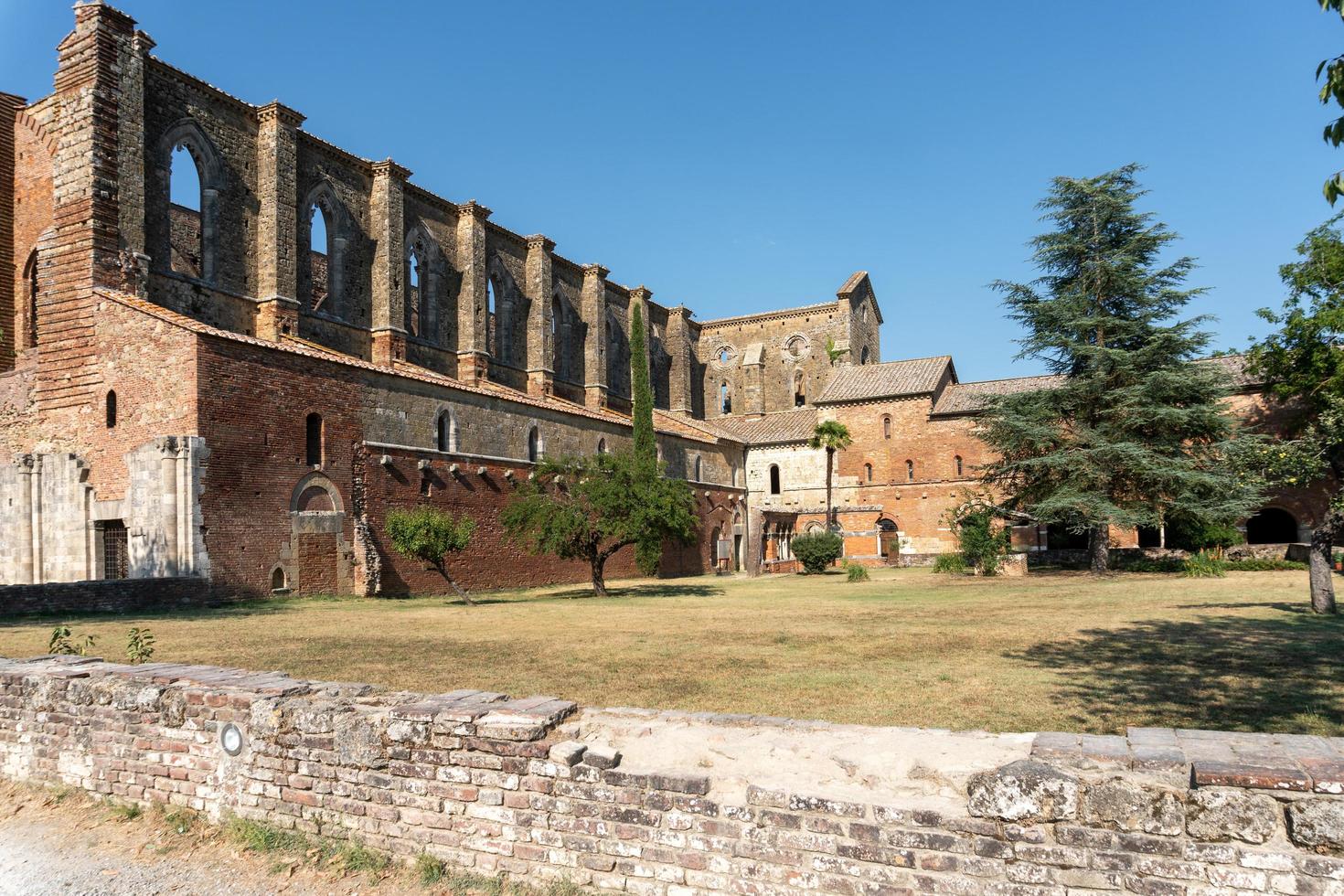San Galgano ,Italy-august 8,2020-view of the abbey and former monastery of San Galgano famous for being roofless during a sunny day in Tuscany photo