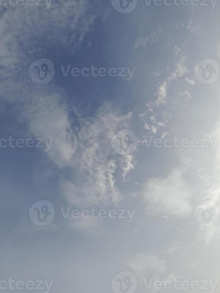 Beautiful white clouds on deep blue sky background. Large bright soft fluffy clouds are cover the entire blue sky. photo