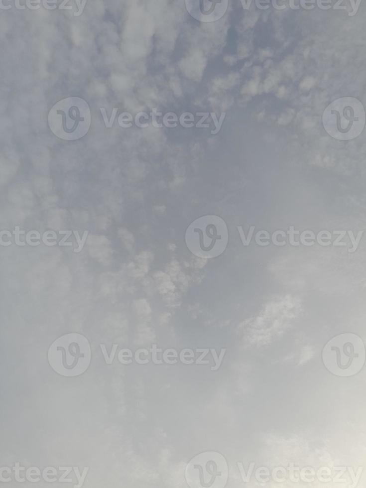 Beautiful white clouds on deep blue sky background. Large bright soft fluffy clouds are cover the entire blue sky. photo