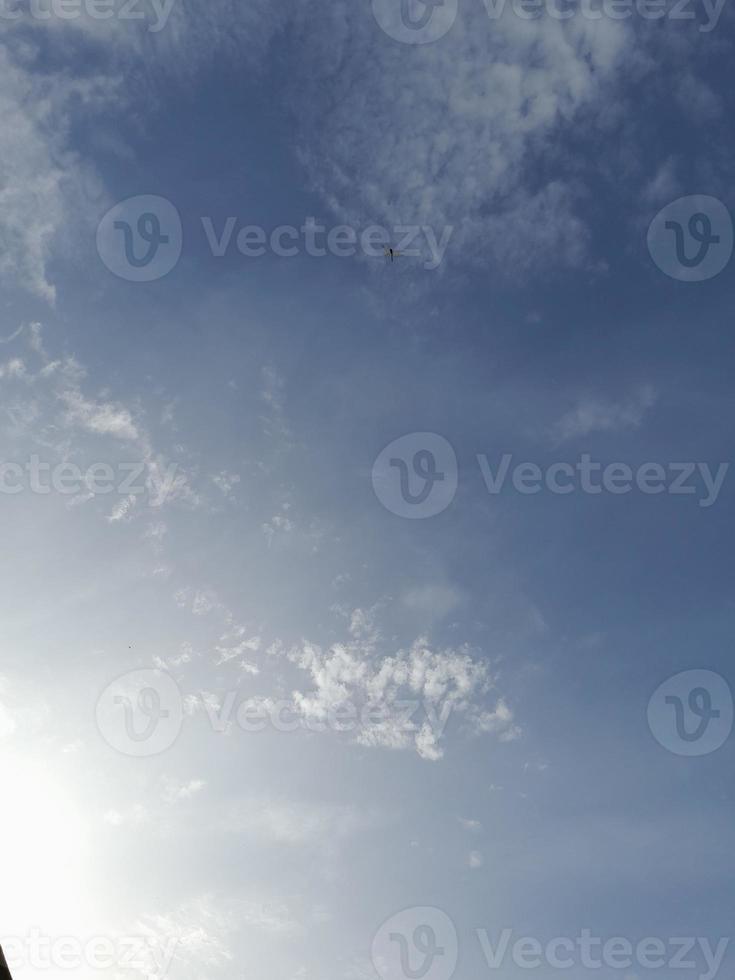 Beautiful white clouds on deep blue sky background. Large bright soft fluffy clouds are cover the entire blue sky. photo