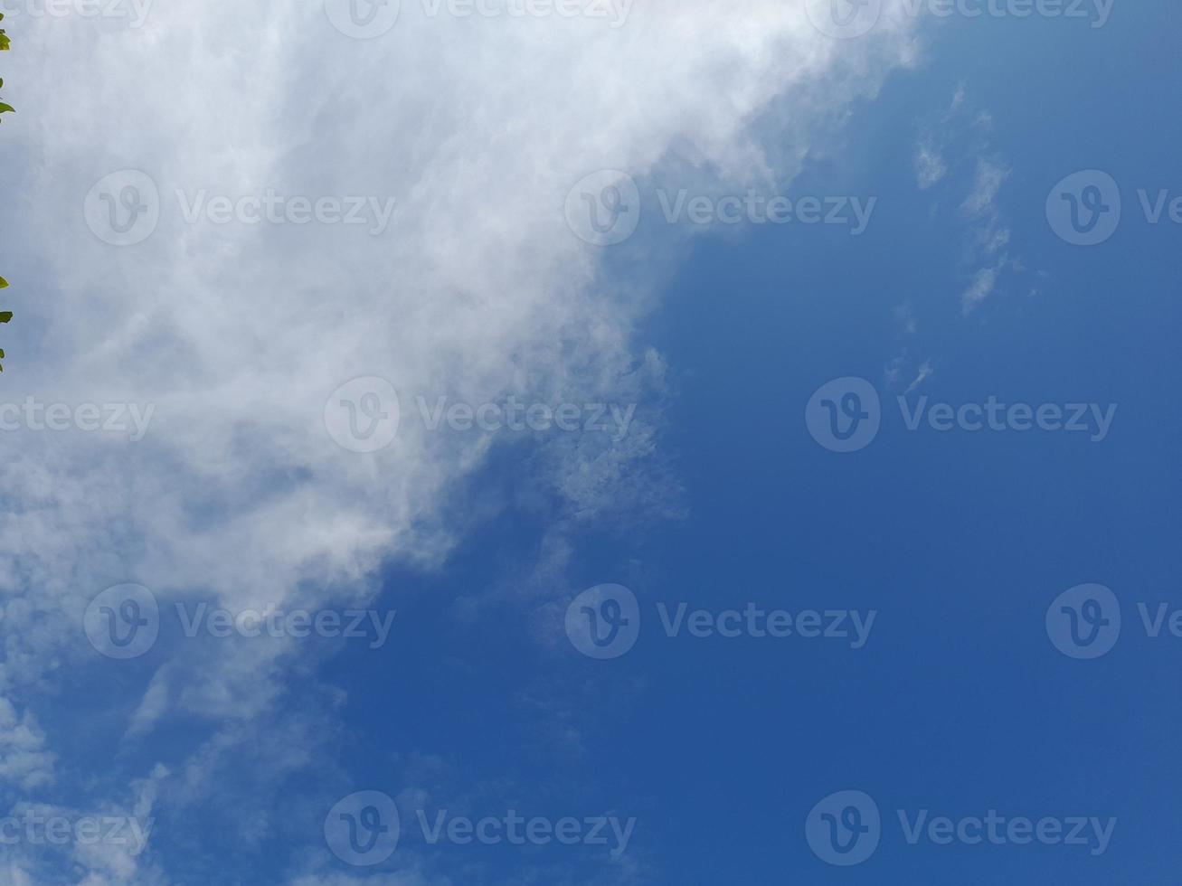 Beautiful white clouds on deep blue sky background. Large bright soft fluffy clouds are cover the entire blue sky. photo