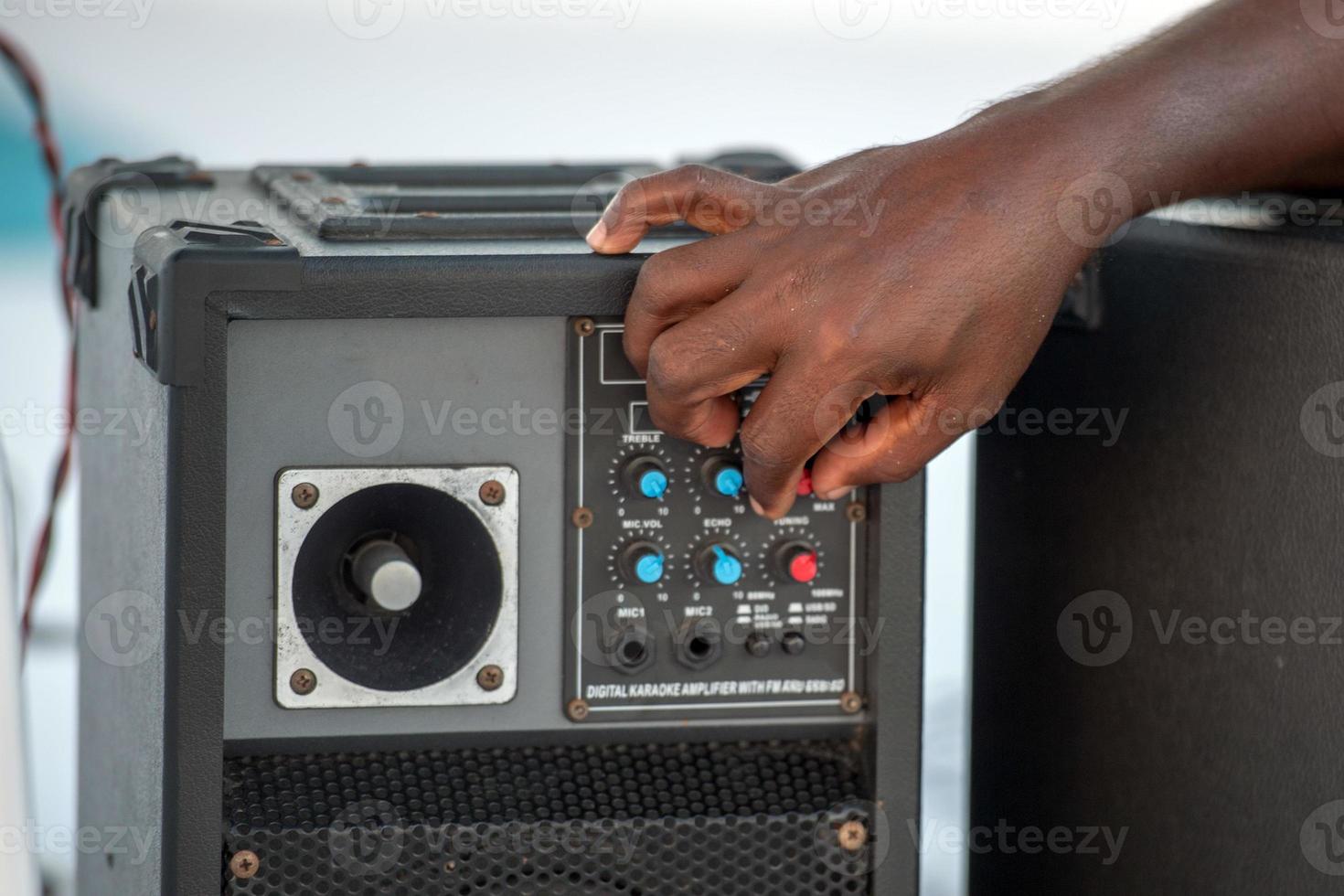 hand on speaker volume detail photo