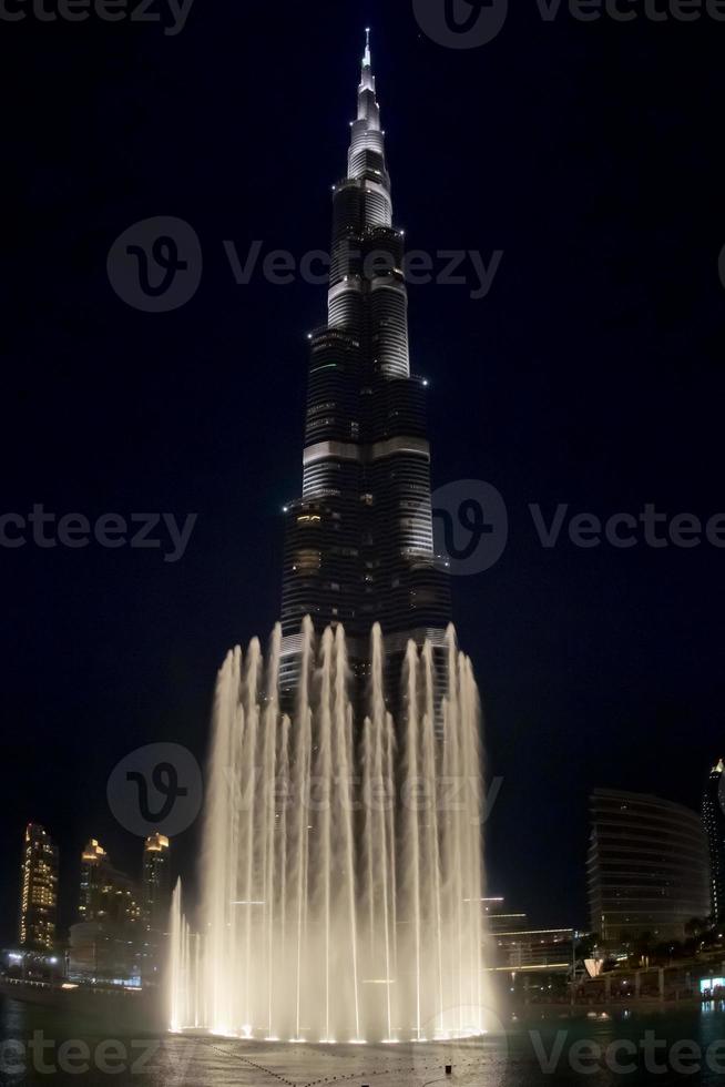 DUBAI, UAE - OCTOBER 2012 Burji Khalifa at night with fountain show the highest building in the world photo