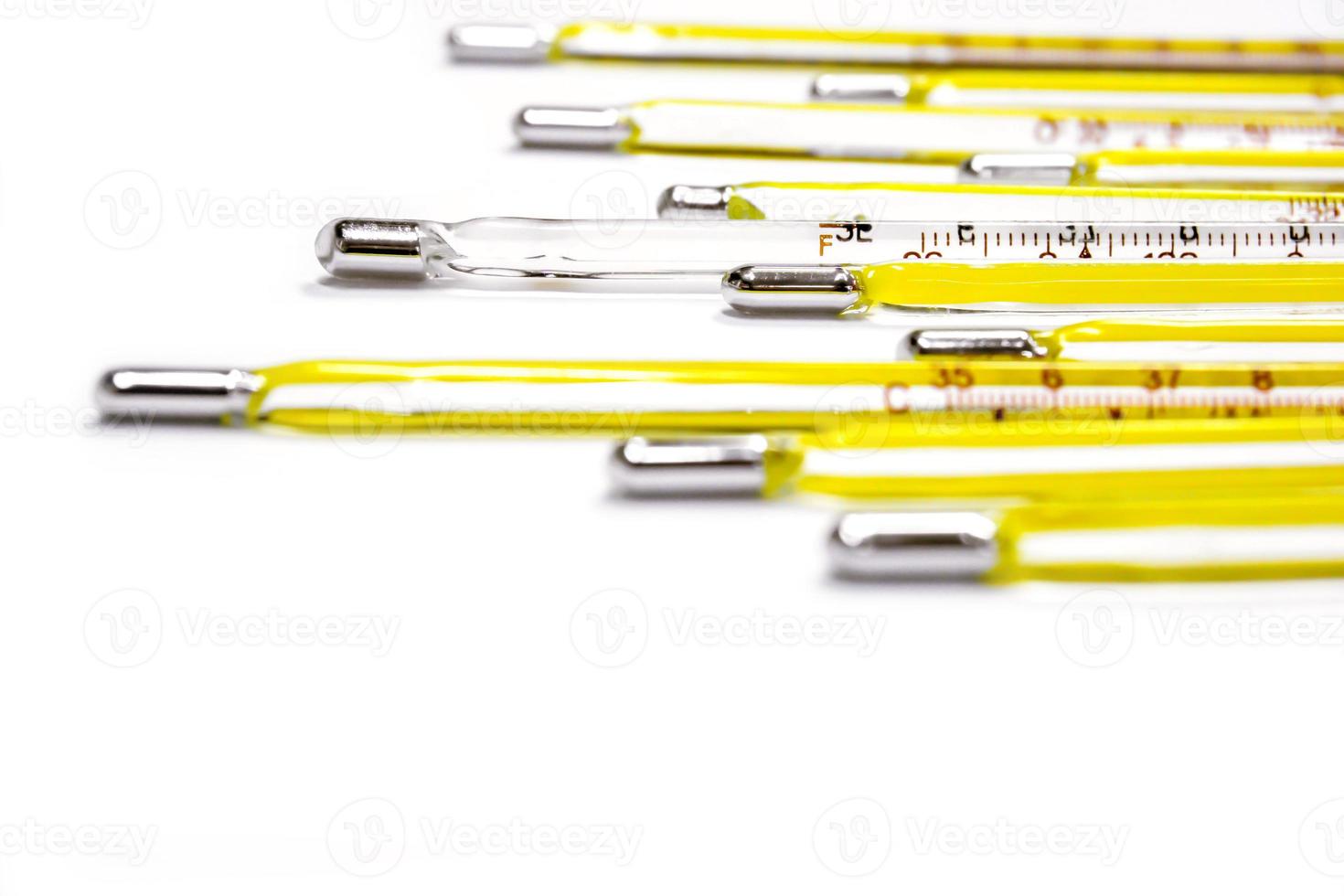 Closeup and crop small medical thermometers line up isolate on white background. photo