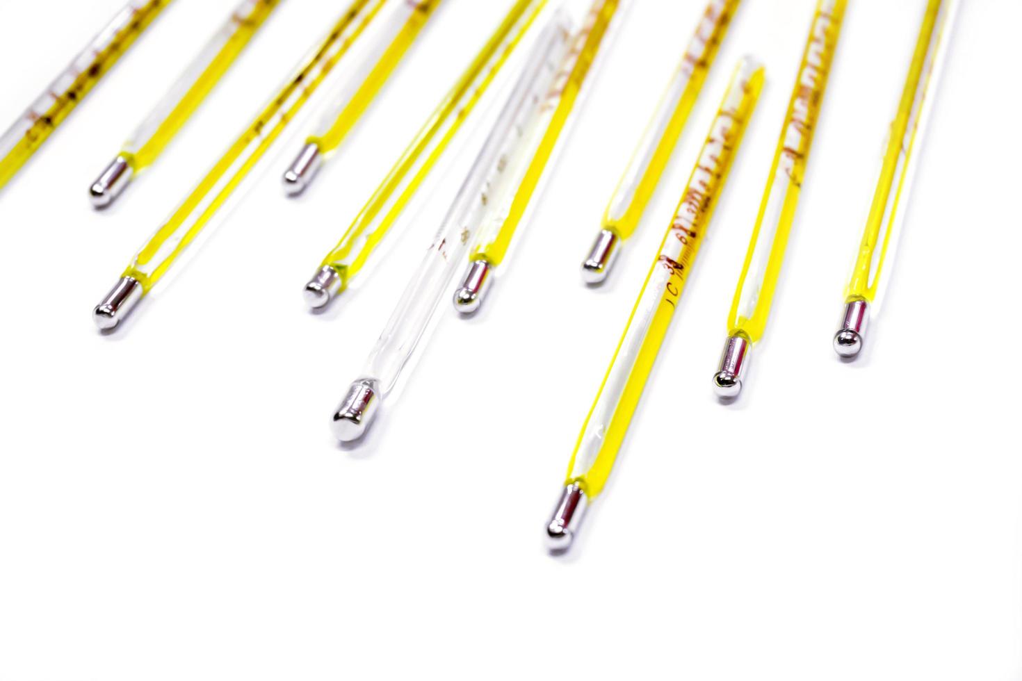 Closeup and crop small medical thermometers line up isolate on white background. photo