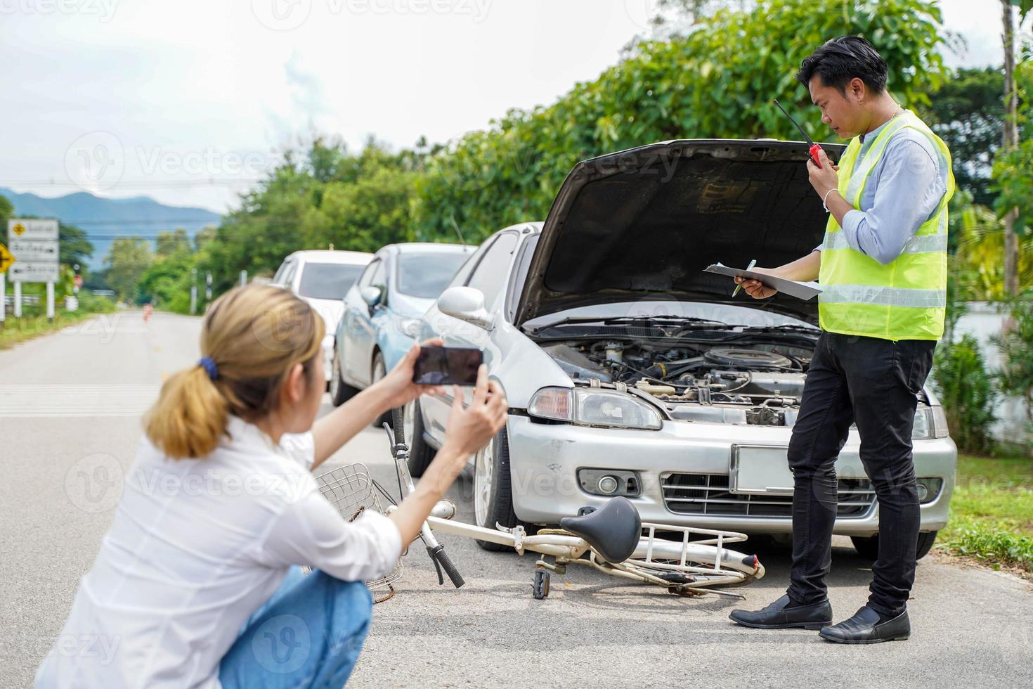 Closeup insurance company officers are using mobile phones to take photos and radio communication as evidence for customer insurance car claims out door background.