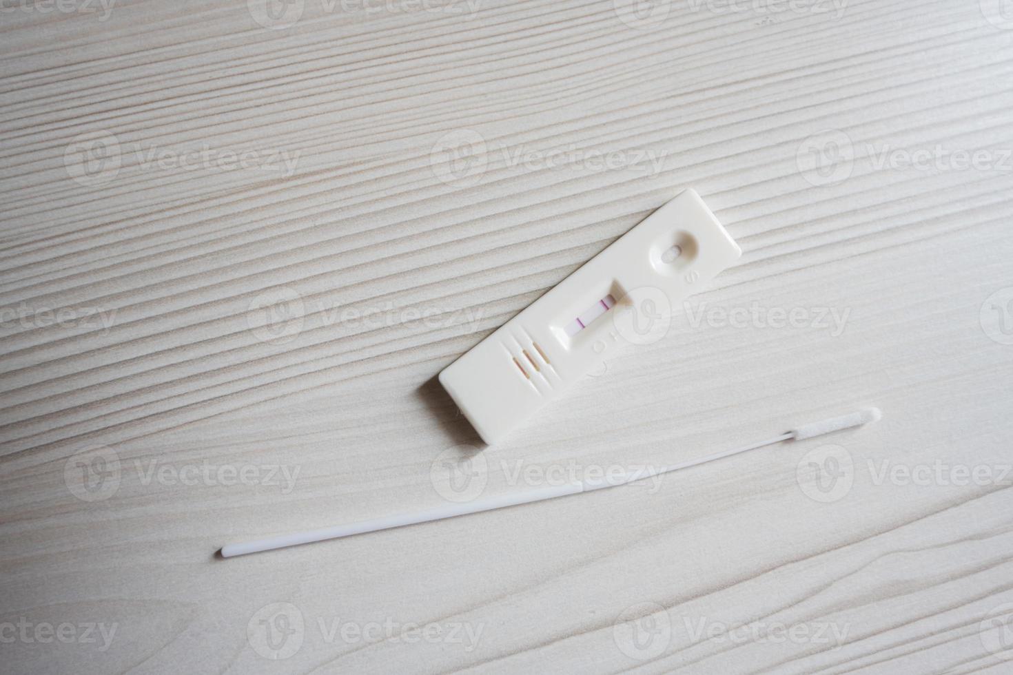 Positive SARS Covid antigen test kit, rapid test, saliva swab,  box with imagine of lungs. photo