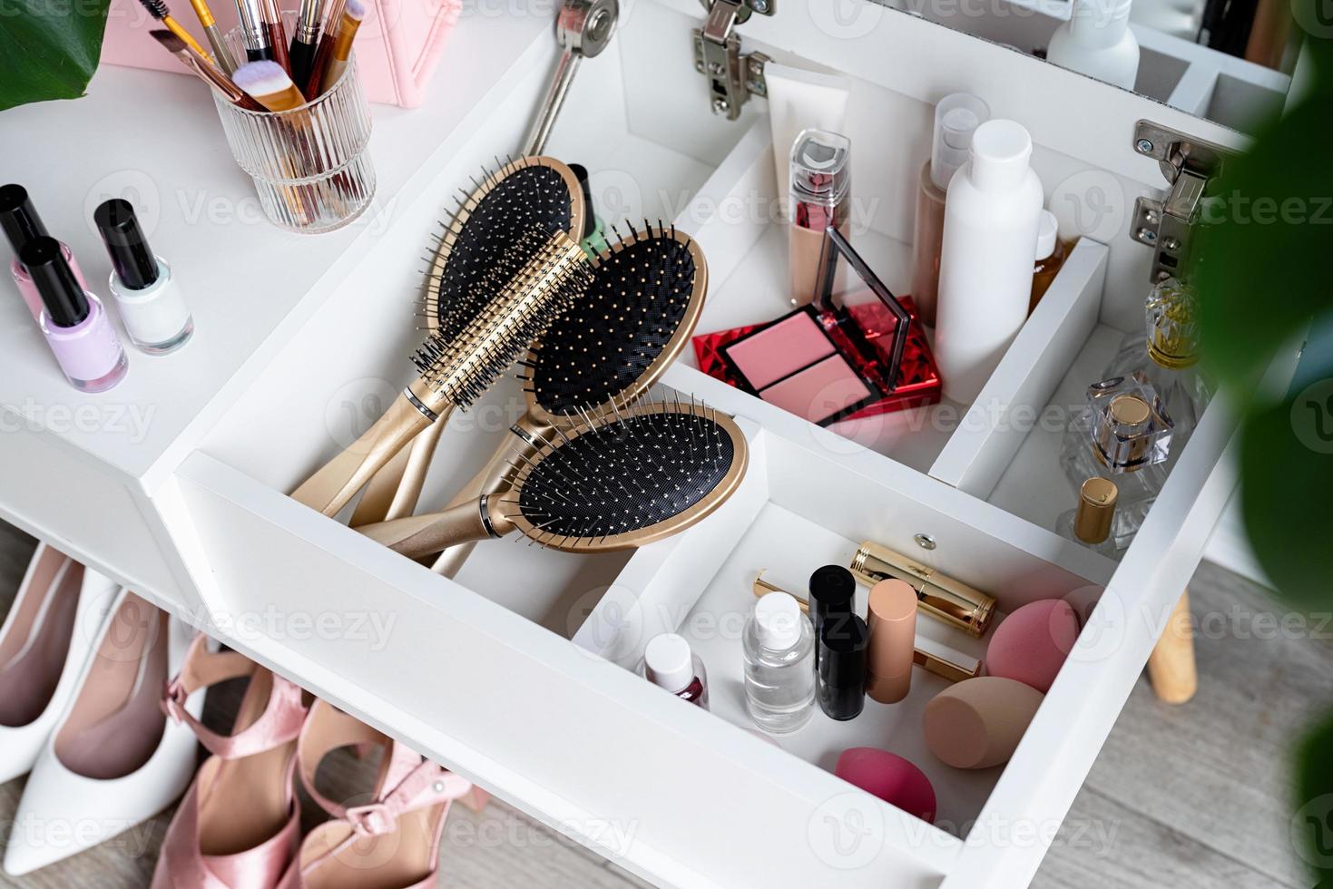 closeup of elegant high heel shoes standing under feminine dressing table photo