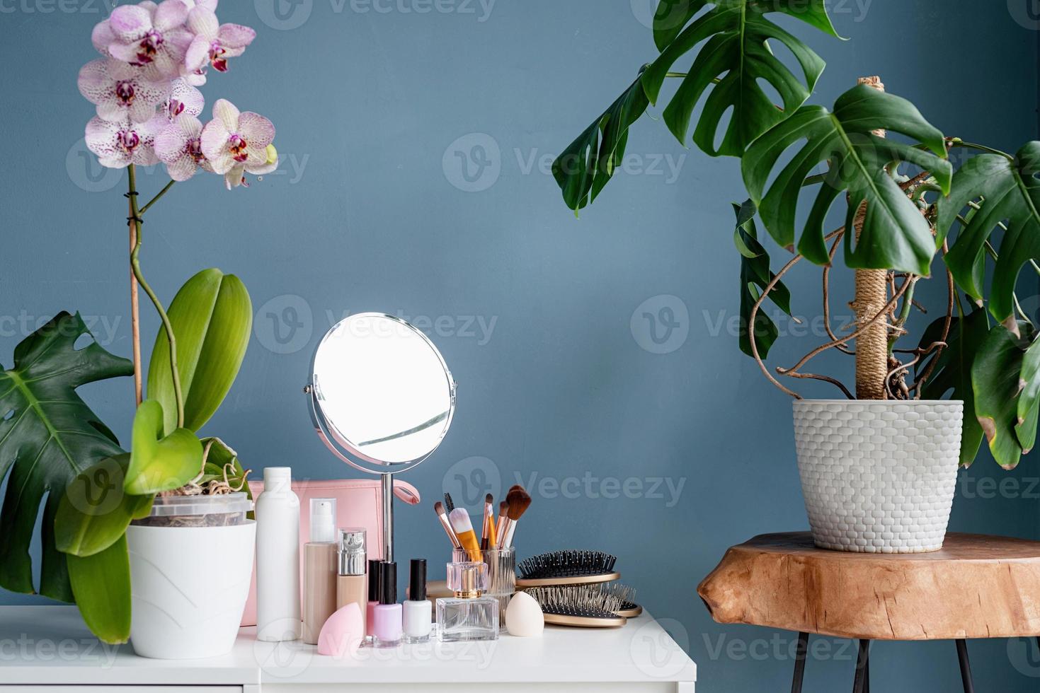 Stylish room interior with elegant dressing table and plants photo