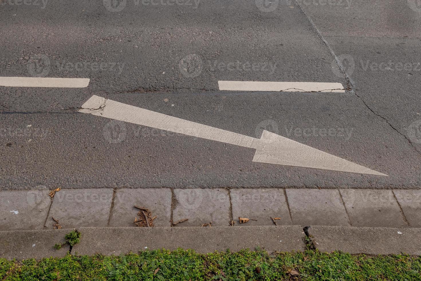 an arrow on a road photo