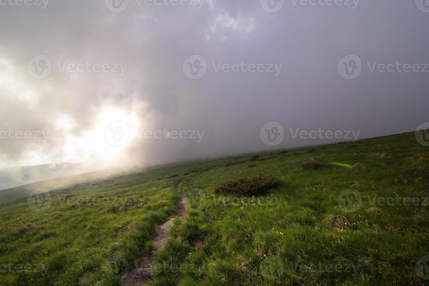 Low-lying mist above grass hill landscape photo