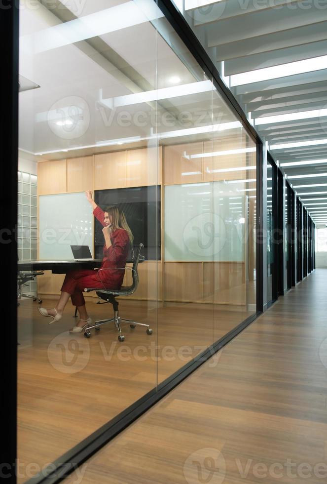 Business woman in red dress, Expressing joy that the presentation of new work and projects to the management team was approved. photo